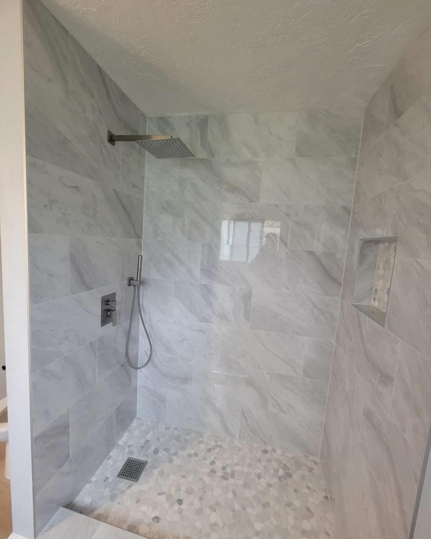 Marble walk-in shower bathroom remodel by Art & Floors
