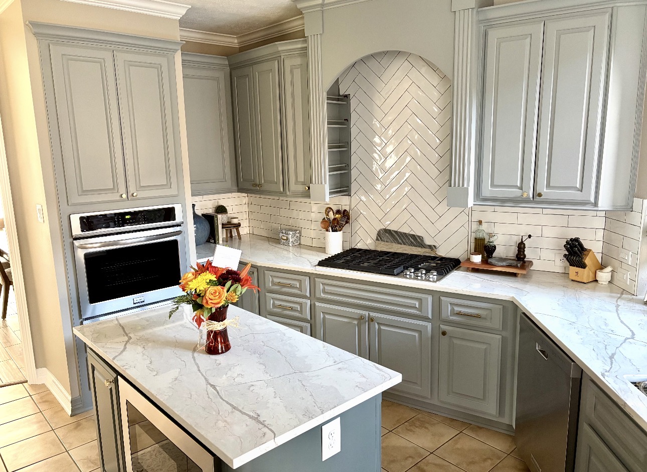 Kitchen remodel with refinished cabinets and quartz counters by Art & Floors
