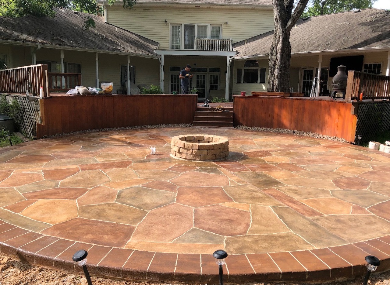 Stained decorative concrete patio with fire pit