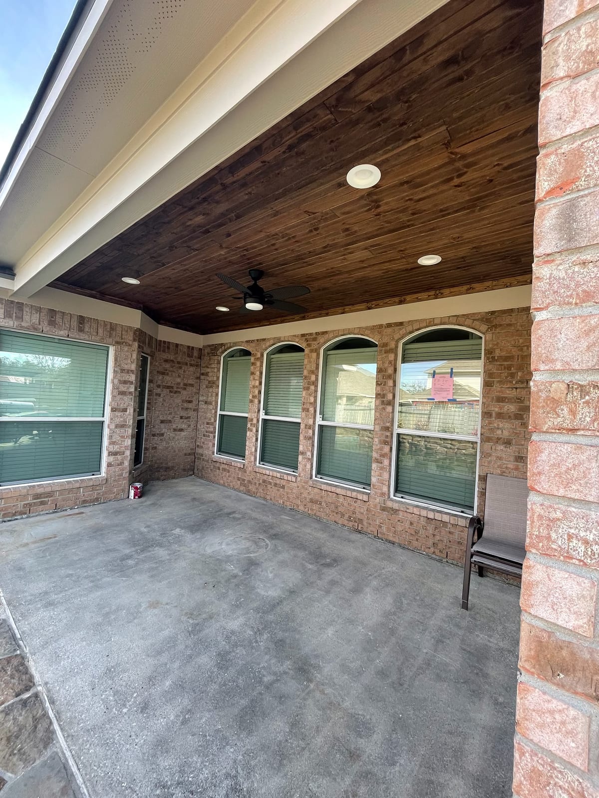 Covered patio with stained wood ceiling