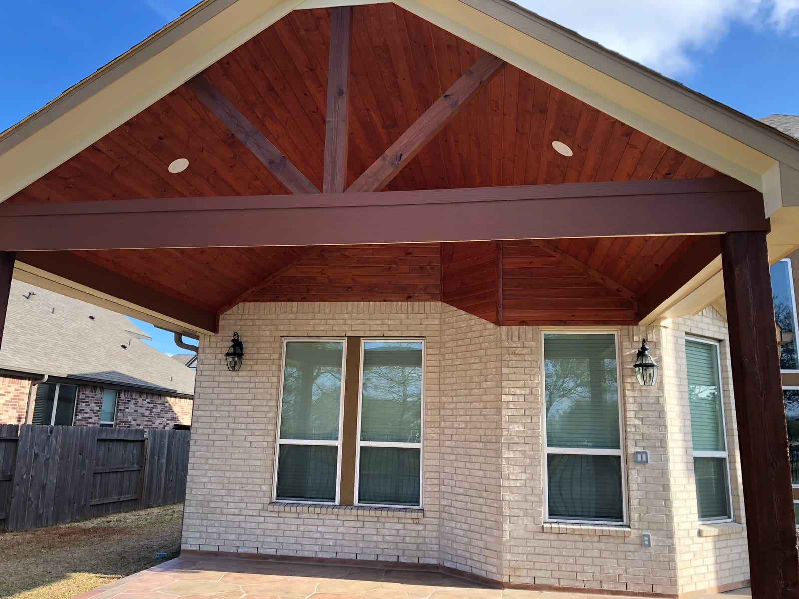 Gable covered patio with cedar ceiling by Art & Floors