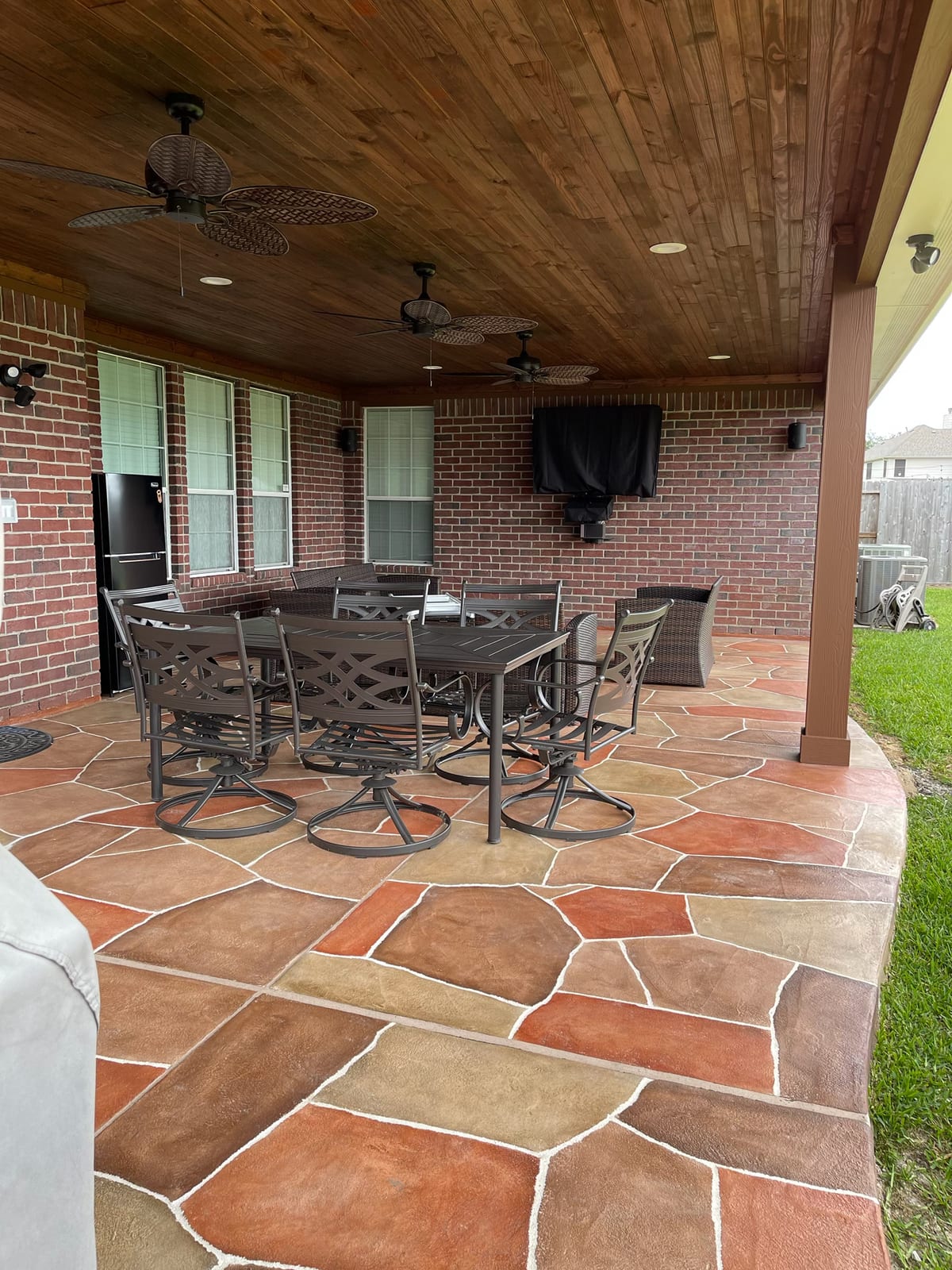 Covered patio outdoor living and dining area with wood ceiling